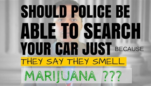 Banner that reads “Should Police Be Able to Search Your Car Just Because They Say They Smell Marijuana???” in front of a blurred background of columns at a courthouse