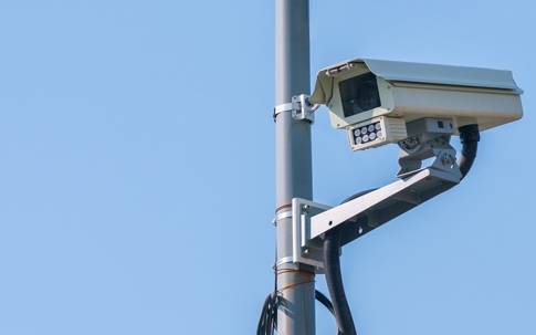 A close-up of a traffic camera mounted on a metal pole. | Shapiro Zwanetz & Lake